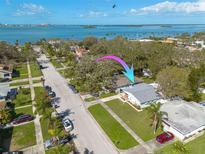 Beautiful waterfront home with mature trees and lush landscaping, near the bay with stunning views at 1044 Charles St, Clearwater, FL 33755