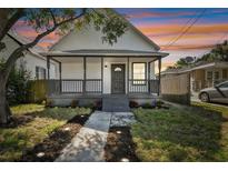 Charming home featuring a covered front porch and newly landscaped front yard at 1106 W La Salle St, Tampa, FL 33607