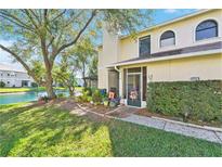 Charming two-story home with a well-maintained lawn and scenic lakeside view at 15 Emerald Bay Dr, Oldsmar, FL 34677