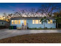 Charming one-story home with blue siding, a paved driveway, and mature trees, perfect for peaceful living at 3307 S Manhattan Ave, Tampa, FL 33629