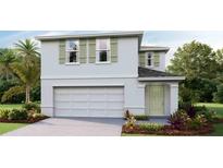 Charming two-story home featuring a spacious two car garage and inviting entryway at 35695 Durand Ct, Zephyrhills, FL 33541