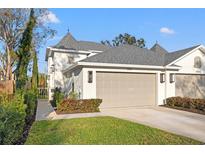 Exterior of home showcasing a two car garage, and well-maintained landscaping at 3721 Iris N St, St Petersburg, FL 33704