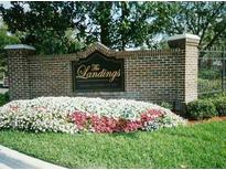 Welcoming brick entrance to The Landings community with lush, colorful landscaping at 4211 Chatham Oak Ct # 122, Tampa, FL 33624