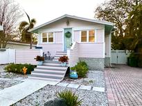 Charming home showcasing a welcoming front entrance with colorful flower arrangements and a wreath on the door at 652 Ohio Pl, Sarasota, FL 34236