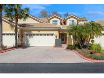 Charming home featuring a three car garage, tile roof, and beautifully landscaped front yard at 7313 Gaberia Rd, Trinity, FL 34655