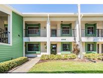Inviting two-story condo with a lush green lawn and charming balconies, offering a warm, welcoming curb appeal at 2549 Royal Pines Cir # 16H, Clearwater, FL 33763