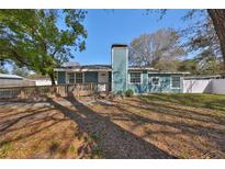 Charming single-story home with blue siding, a walkway ramp, and a chimney at 3127 W Lambright St # A, Tampa, FL 33614