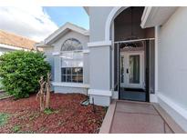 Well-maintained single-story home displaying an arched front entryway at 9376 French Quarters Cir, Weeki Wachee, FL 34613