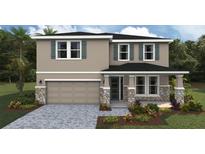 Charming two-story home featuring stone accents, a two-car garage, and well-manicured landscaping at 17065 James Trl, Parrish, FL 34219