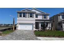 Charming two-story home with a paved driveway, manicured lawn, and a two-car garage at 1741 Cobb Trl, Parrish, FL 34219