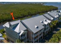 Stunning waterfront condo featuring a durable metal roof and balconies overlooking the serene river at 3230 Mangrove Point Dr, Ruskin, FL 33570