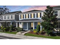 Charming two-story home featuring blue siding, black shutters, and a welcoming front porch with well-maintained landscaping at 637 Jetstar Ln, Oldsmar, FL 34677
