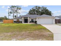 Charming single-story home with well-maintained landscaping, a two-car garage, and a welcoming front entrance at 10424 Gifford Dr, Spring Hill, FL 34608