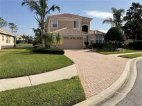 Charming two-story home boasts a tile roof, well-manicured lawn, and brick driveway at 11477 Tinder Ct, Venice, FL 34292