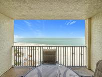 Enjoy breathtaking ocean views from the private balcony with comfortable seating and a table at 12924 Gulf Blvd # 503, Madeira Beach, FL 33708