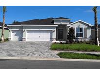 Charming one-story home with three-car garage, stone accents, and manicured landscaping at 17126 James Trl, Parrish, FL 34219