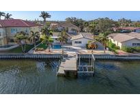 Waterfront home with boat dock and lift, featuring a private pool and lush tropical landscaping at 1984 Kansas Ne Ave, St Petersburg, FL 33703