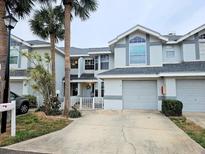 Inviting townhouse with charming curb appeal and a well-maintained front yard at 1988 Georgia S Cir, Clearwater, FL 33760