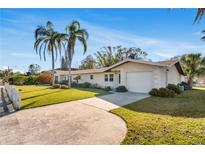Single-story home with a white picket fence, driveway, and a well-manicured lawn at 200 S Bayshore Blvd, Clearwater, FL 33759