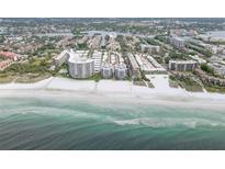 Stunning aerial view of beachfront condos with pristine white sand and turquoise waters at 6310 Midnight Pass Rd # 204N, Sarasota, FL 34242