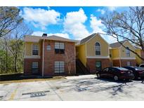 Charming two-story condo building with brick and siding exterior and ample parking at 8659 Fancy Finch Dr # 202, Tampa, FL 33614