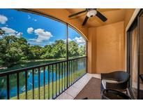 Enjoy this balcony view with black metal railings overlooking a beautiful water view with green trees at 2138 Chianti Pl # 142, Palm Harbor, FL 34683