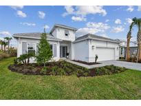 Beautiful two-story home with a manicured front yard and a two car garage at 29423 Toricelli Rd, Wesley Chapel, FL 33543