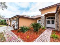 Charming single-story home with well-maintained landscaping, brick accents, and a welcoming double-door entrance at 3701 Barnhouse Pl, Valrico, FL 33596