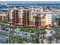 Exterior of a modern condo building with tropical landscaping and ample parking at 5301 Gulf Blvd # C202, St Pete Beach, FL 33706