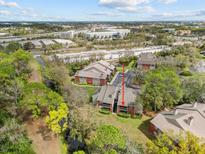 Scenic aerial view of brick condos surrounded by lush greenery, waterway, and city views at 9100 Dr Martin Luther King Jr N St # 1508, St Petersburg, FL 33702
