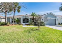 Charming single-story home with well-maintained lawn, mature landscaping, and two-car garage at 10237 Collar Dr, San Antonio, FL 33576
