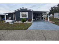 Charming single-story home with a covered parking area and well-maintained landscaping at 1710 7Th Sw St # 93, Ruskin, FL 33570