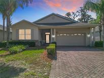Charming single-story home with brick-paved driveway and well-manicured landscaping at 19724 Fort King Run, Brooksville, FL 34601