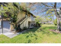 Charming exterior view of the building, with stairs, a small front yard, and lush landscaping at 2934 Lichen Ln # C, Clearwater, FL 33760
