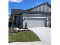 Charming single-Gathering home featuring a two-car garage, fresh landscaping, and a light gray color scheme at 3681 Nandina Cir, Sun City Center, FL 33573