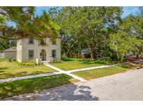 Charming home with a well-manicured lawn and mature trees providing shade at 7125 6Th N Ave, St Petersburg, FL 33710