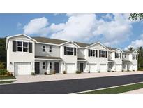 New townhome with a driveway and garage, plus decorative shutters and front lawn at 17457 Haysack Ter, Lakewood Ranch, FL 34211