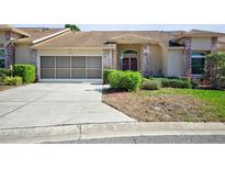 Charming home with well-maintained lawn, screen garage, brick accents and inviting entrance at 2348 Rolling View Dr, Spring Hill, FL 34606