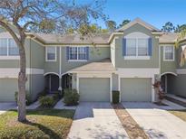 Inviting townhouse showcases a well-maintained front exterior and attached one-car garage with pleasant curb appeal at 2712 Conch Hollow Dr, Brandon, FL 33511