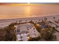 Stunning beach home with sunrise views, palm trees, and spacious beachfront property at 3351 Gulf Of Mexico Dr, Longboat Key, FL 34228