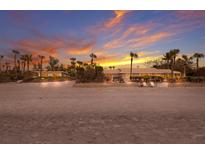 Stunning beachfront home featuring palm trees, panoramic ocean views, and direct access to the pristine sandy beach at 3351 Gulf Of Mexico Dr, Longboat Key, FL 34228