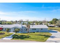 Charming single-story home with a well-maintained lawn and a classic, light gray exterior at 541 Ridgecrest Dr, Punta Gorda, FL 33982