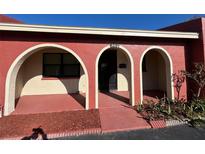 Charming home featuring arched entryways and freshly manicured landscaping at 6391 Bonnie Bay N Cir, Pinellas Park, FL 33781