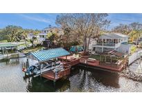 Waterfront home featuring a private dock with boat lift and entertainment area at 9920 Alavista Dr, Gibsonton, FL 33534