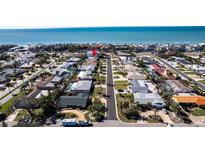 Aerial view of the neighborhood with blue ocean in the distance at 102 23Rd St, Belleair Beach, FL 33786