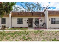 Charming townhome with neutral exterior, covered porch, and well-maintained landscaping at 1273 Mission Cir, Clearwater, FL 33759
