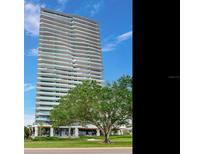 Striking high-rise condominium with wrap-around balconies, manicured lawns, and lush greenery at 2912 W Santiago St # 1504, Tampa, FL 33629