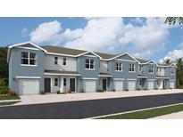 Row of two-story townhomes featuring blue paint, light-colored doors, and a garage at 4113 Goldheart Blvd, Bradenton, FL 34208