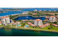 Stunning aerial view of waterfront condos and beautiful blue water with bridges and lush greenery at 6290 Bahia Del Mar Cir # 5, St Petersburg, FL 33715