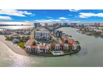 Beautiful aerial view showcasing the waterfront property and its community pool in a desirable location at 855 Bayway Blvd # 105, Clearwater, FL 33767